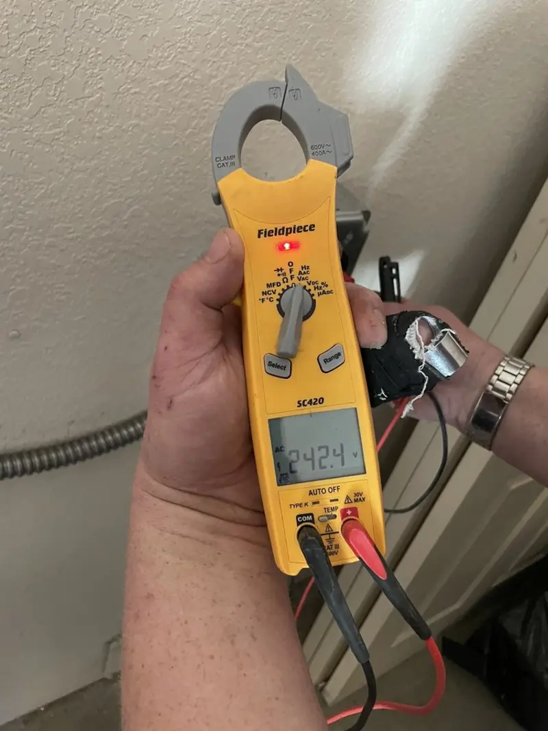 Voltage testing with clamp meter during Outlet Installation in Deschutes River Woods